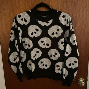 Black knit sweater with white skull design all over. Shein
